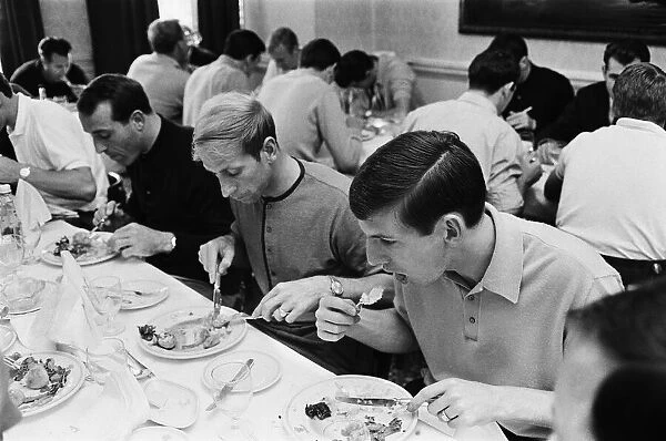 Members of the England football team Bobby Charlton and Martin Peters eating breakfast at