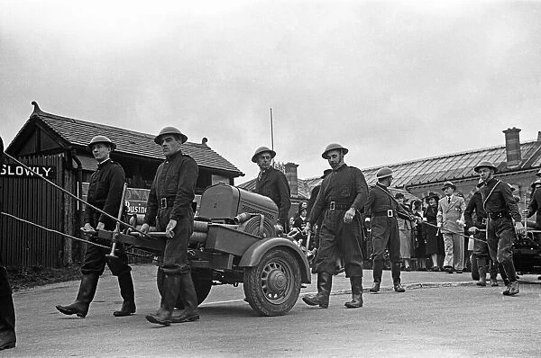 Members of the Esher Auxiliary Fire Service parade with their Coventry Climax pump at a