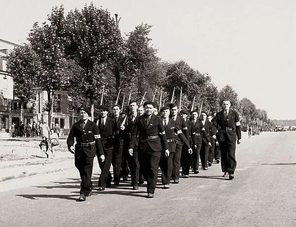 Members of the FFI Resistance movement parade through Paris following the liberation of
