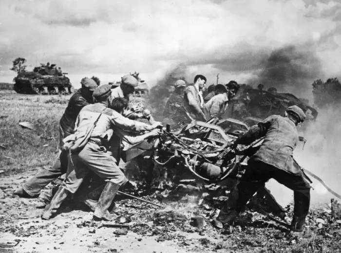 Framed Print : Members of the French Forces of the Interior clear away burning vehicles on the main road
