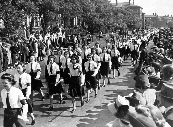 Members of the Girls Training Corps, Liverpool, marching past the saluting crows at