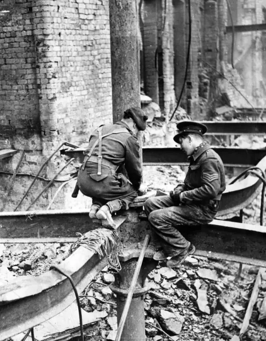 Framed Print : Members of H. M Forces perched on a girder as they place a charge of gelignite in position Framed Print : Members of H. M Forces perched on a girder as they place a charge of gelignite in position