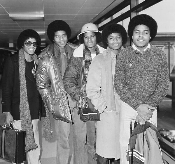 Members of The Jackson Five pop group make their way through the arrivals hall as they
