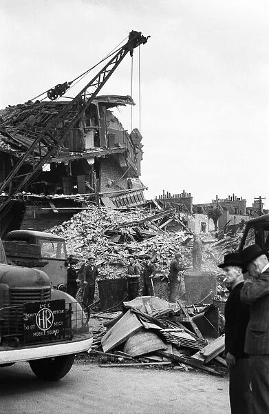 Members of the LCC salvage squad and members of the ARP search the rubble of a V1