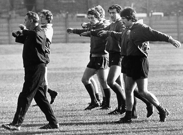 Members of the Liverpool first team are given breathing exercises by trainer Joe Fagan