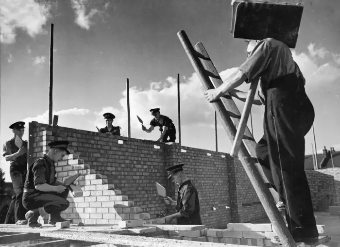 Framed Print : Members of The National Fire Service, building their own fire station