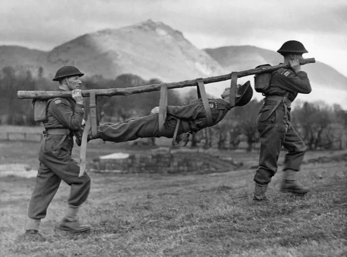 Framed Print : Members of the Royal Army Medical Corps improvise a stretcher for a casualty during a