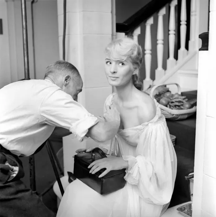 Framed Print : Members of the Wardrobe and make-up departments at Pinewood Studios help the actresses Framed Print : Members of the Wardrobe and make-up departments at Pinewood Studios help the actresses