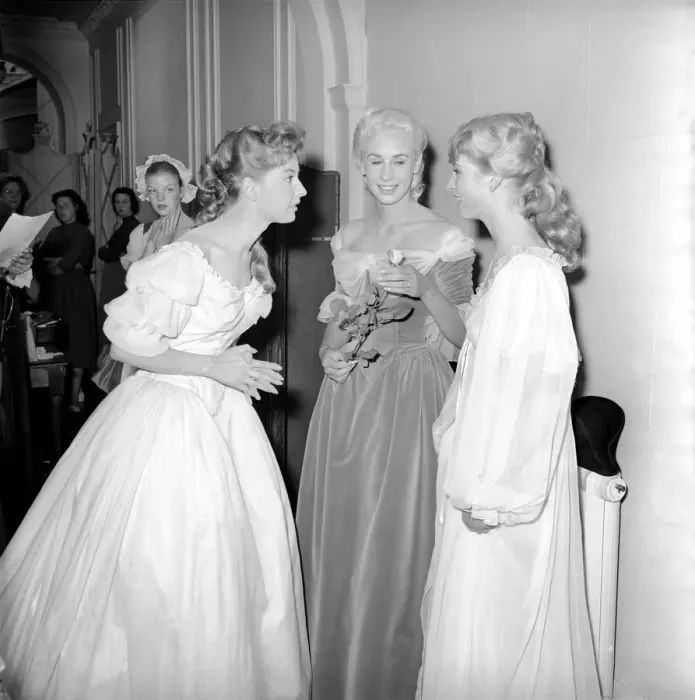 Framed Print : Members of the Wardrobe and make-up departments at Pinewood Studios help the actresses Framed Print : Members of the Wardrobe and make-up departments at Pinewood Studios help the actresses