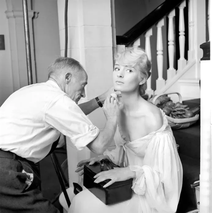 Framed Print : Members of the Wardrobe and make-up departments at Pinewood Studios help the actresses Framed Print : Members of the Wardrobe and make-up departments at Pinewood Studios help the actresses