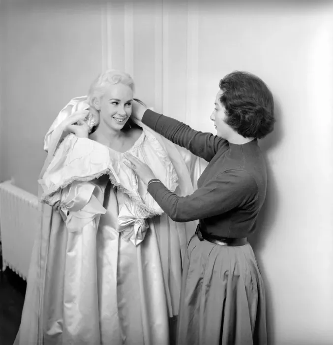 Framed Print : Members of the Wardrobe and make-up departments at Pinewood Studios help the actresses Framed Print : Members of the Wardrobe and make-up departments at Pinewood Studios help the actresses