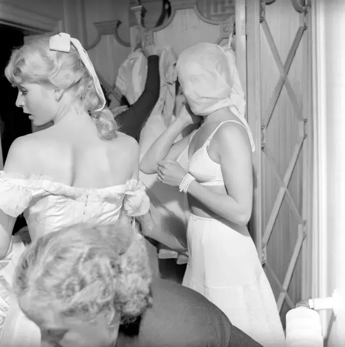 Framed Print : Members of the Wardrobe and make-up departments at Pinewood Studios help the actresses Framed Print : Members of the Wardrobe and make-up departments at Pinewood Studios help the actresses