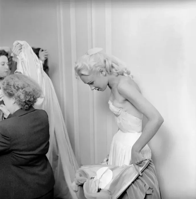 Framed Print : Members of the Wardrobe and make-up departments at Pinewood Studios help the actresses Framed Print : Members of the Wardrobe and make-up departments at Pinewood Studios help the actresses