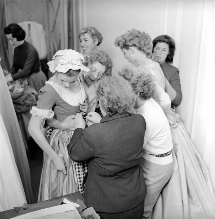 Framed Print : Members of the Wardrobe and make-up departments at Pinewood Studios help the actresses Framed Print : Members of the Wardrobe and make-up departments at Pinewood Studios help the actresses