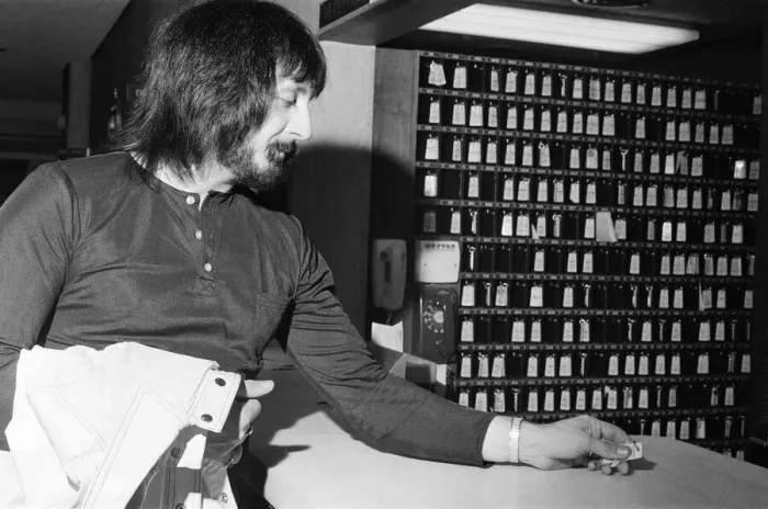 Framed Print : Members of The Who rock group. Bass guitarist John Entwistle hands in his hotel key Framed Print : Members of The Who rock group. Bass guitarist John Entwistle hands in his hotel key