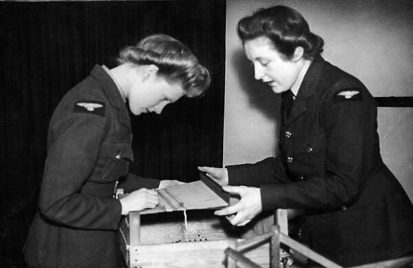 Members of the Womens Auxiliary Air Force being taught the age old craft of '