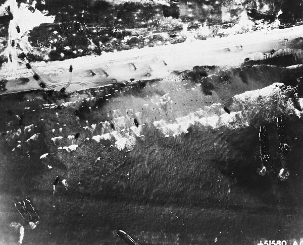 Men and assault vehicles storm the beaches at Normandy, Northern France as Allied landing