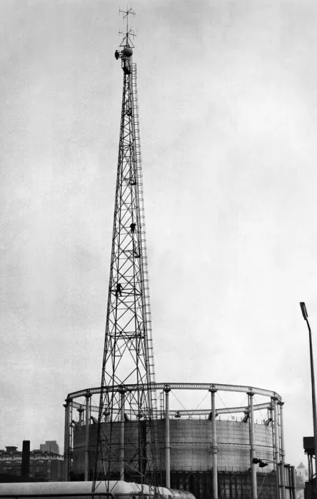 Framed Print : Men balance precariously 100ft up the radio mast at Gaythorn Gas Works Framed Print : Men balance precariously 100ft up the radio mast at Gaythorn Gas Works