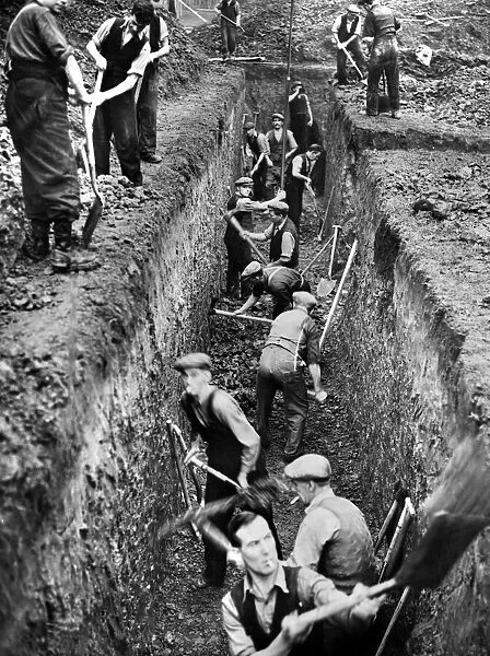 Men digging deep trenches in Birkenhead Park, which will become shelters