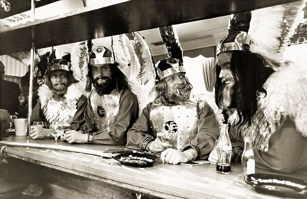 Men drinking in a pub in Knightsbridge London wearing Viking costume