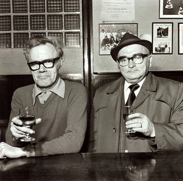 Two men enjoying a drink in their local pub April 1975