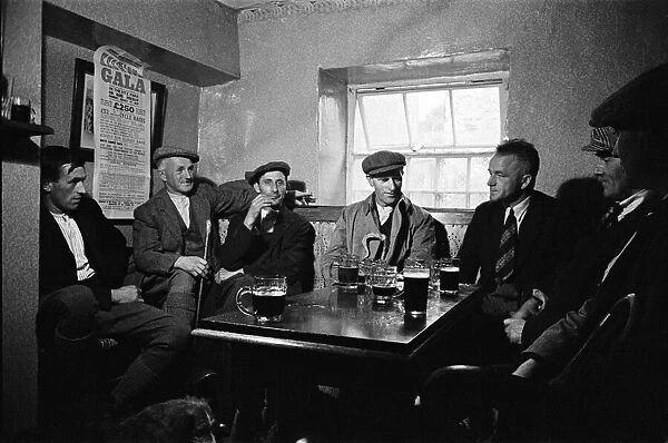 Men enjoying a pint at the Royal Oak Inn, in Braithwaite village near Keswick, Cumbria