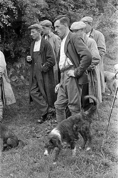 Men gathering to watch sheep shearing in a village near Keswick, Cumbria, circa July 1947