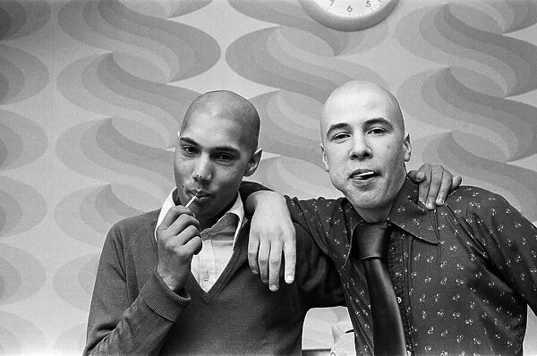 Two men with 'Kojak'hair cuts. 1975