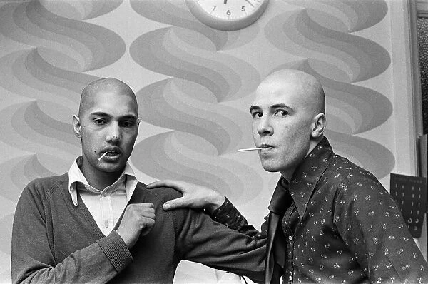 Two men with 'Kojak'hair cuts. 1975