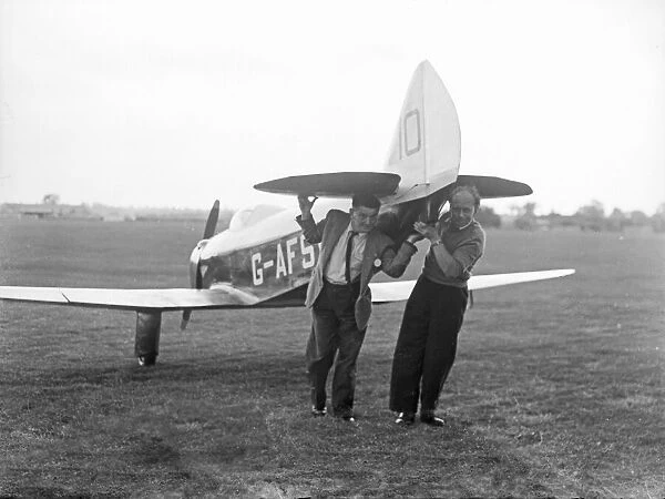 Two men manually transporting a Chilton DW1A across the field at Bagington Circa 1955