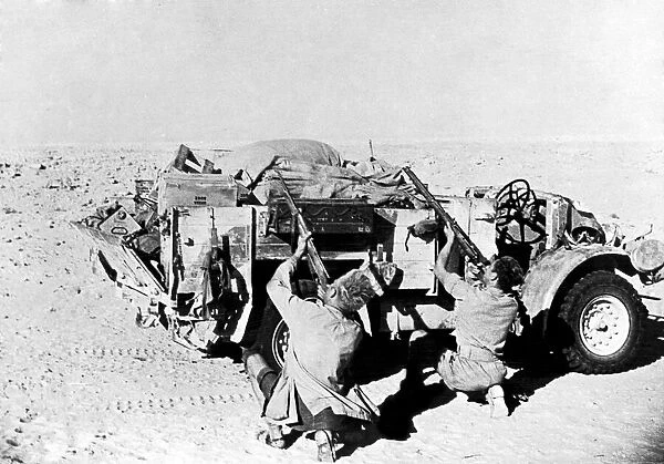 Men of the New Zealand forces take cover behind their truck at El Alamein