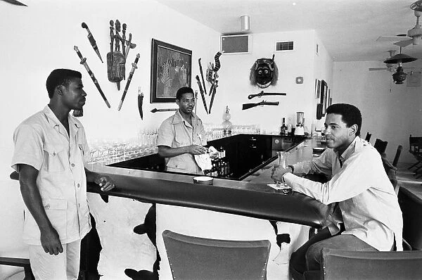Men relax in bar, West Indies, February 1965