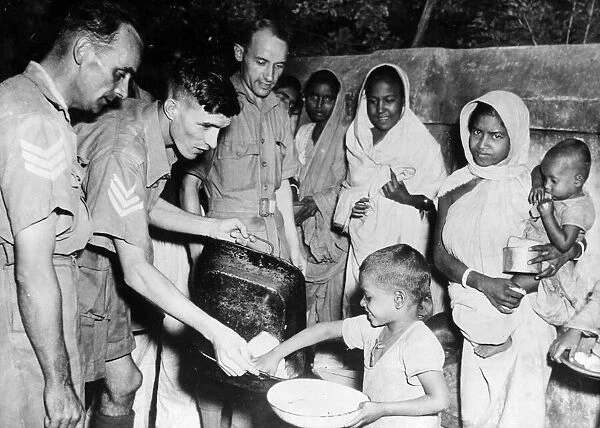 Men of the Royal Air Force feeding local children in tre Indian famine areas at an RAF