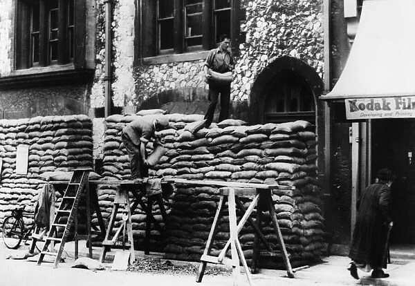 Men sand bagging Market Street Police station, Torquay. Circa August 1939