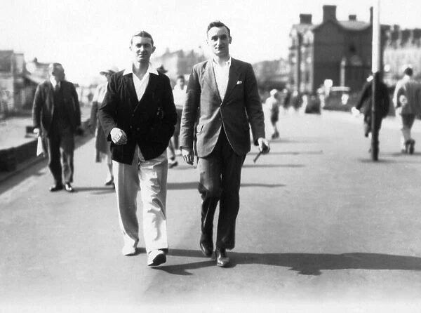 Two men walking along the seafront at Teignmouth, Devon. 1930. Tyrell Collection
