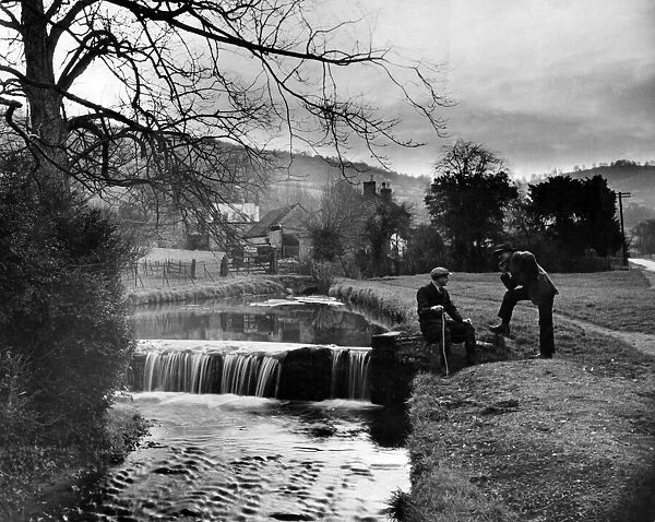 Two men by a waterfall. March 1935