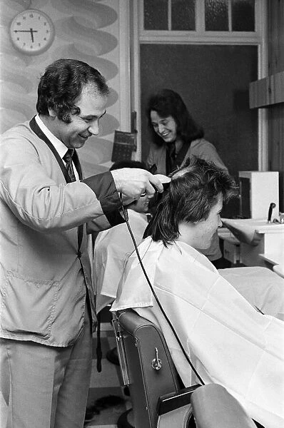 Two men who are getting 'Kojak'hair cuts. 1975