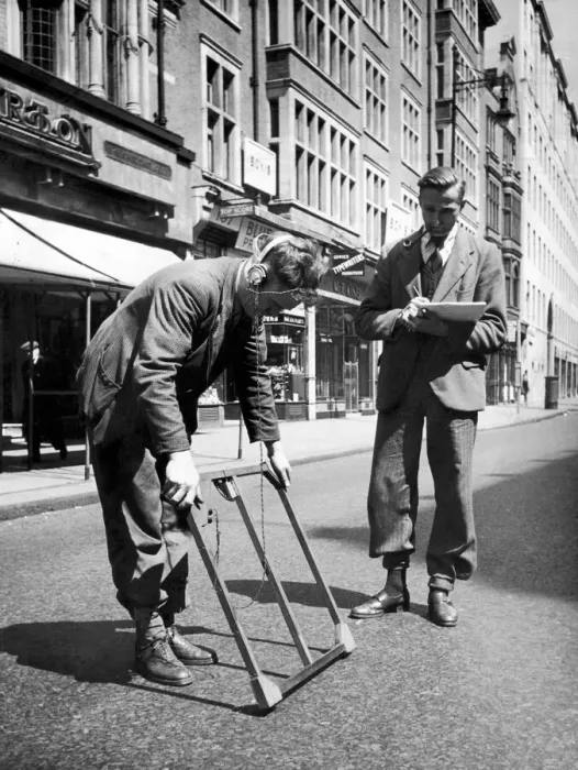 Framed Print : Two men who work for the GPO at work with a mine detector as they try to find a cable of Framed Print : Two men who work for the GPO at work with a mine detector as they try to find a cable of