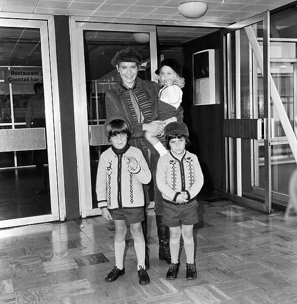 Mia Farrow at Heathrow Airport with her children Sacha, Matthew and Fletcher Previn