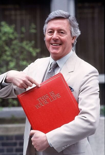 Michael Aspel TV Presenter of this is your life holding red book Dbase MSI