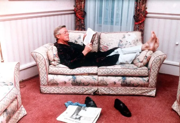 Framed Print : Michael Aspel TV Presenter of This is your Life lying on sofa reading book Framed Print : Michael Aspel TV Presenter of This is your Life lying on sofa reading book