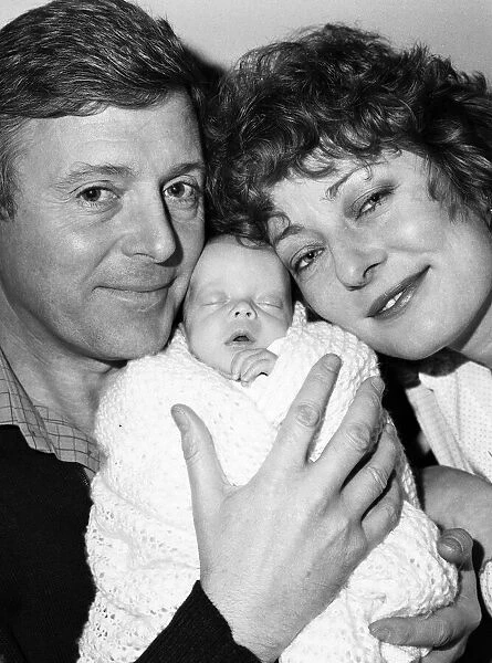 Michael Aspel and his wife Lizzie Power with their newborn son, Patrick