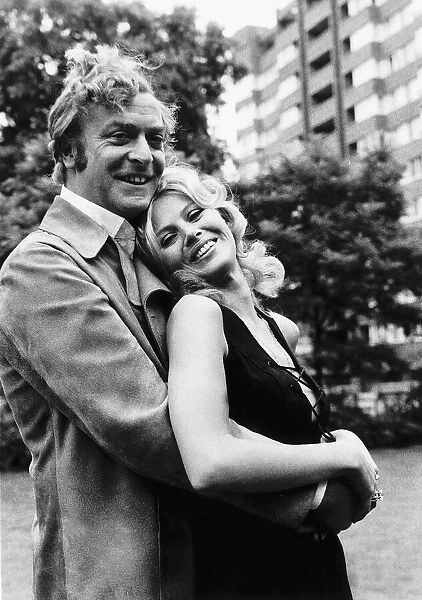 Michael Caine and Britt Ekland pose for photographers during a break in filming Get