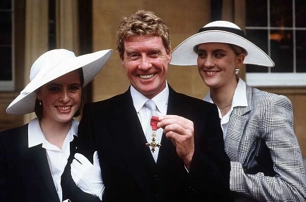 Michael Crawford actor singer receives his MBE from Buckingham Palace with his two