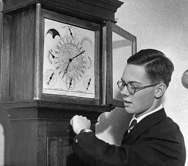 Michael Finnemore checks his watch by his Wonder grandfather clock before it is