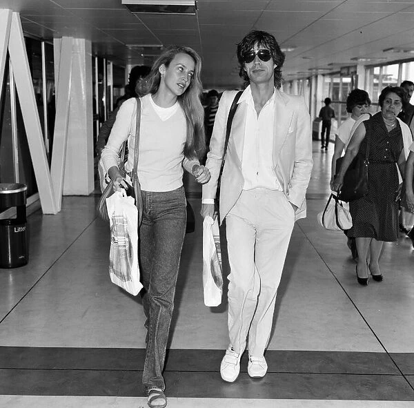 Mick Jagger and girlfriend, model, Jerry Hall, pictured at London Heathrow Airport
