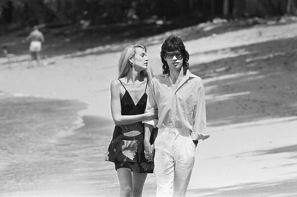 Mick Jagger and Jerry Hall seen here taking a stroll along the beach at Gibbs Bay in