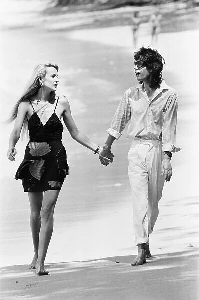 Mick Jagger and Jerry Hall seen here taking a stroll along the beach at Gibbs Bay in