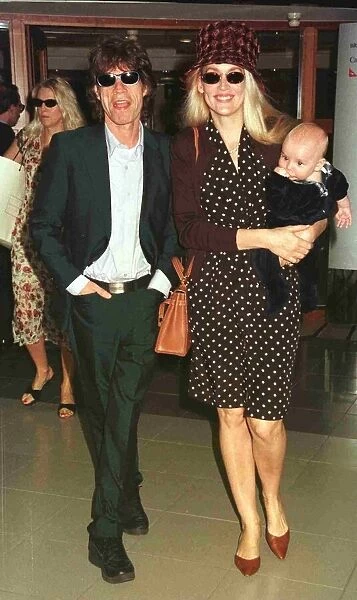 Mick Jagger pop singer and wife Jerry with their new baby leave Heathrow for Nice