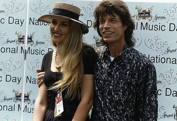 Mick Jagger poses with his wife Jerry Hall at a national music day celebration in London